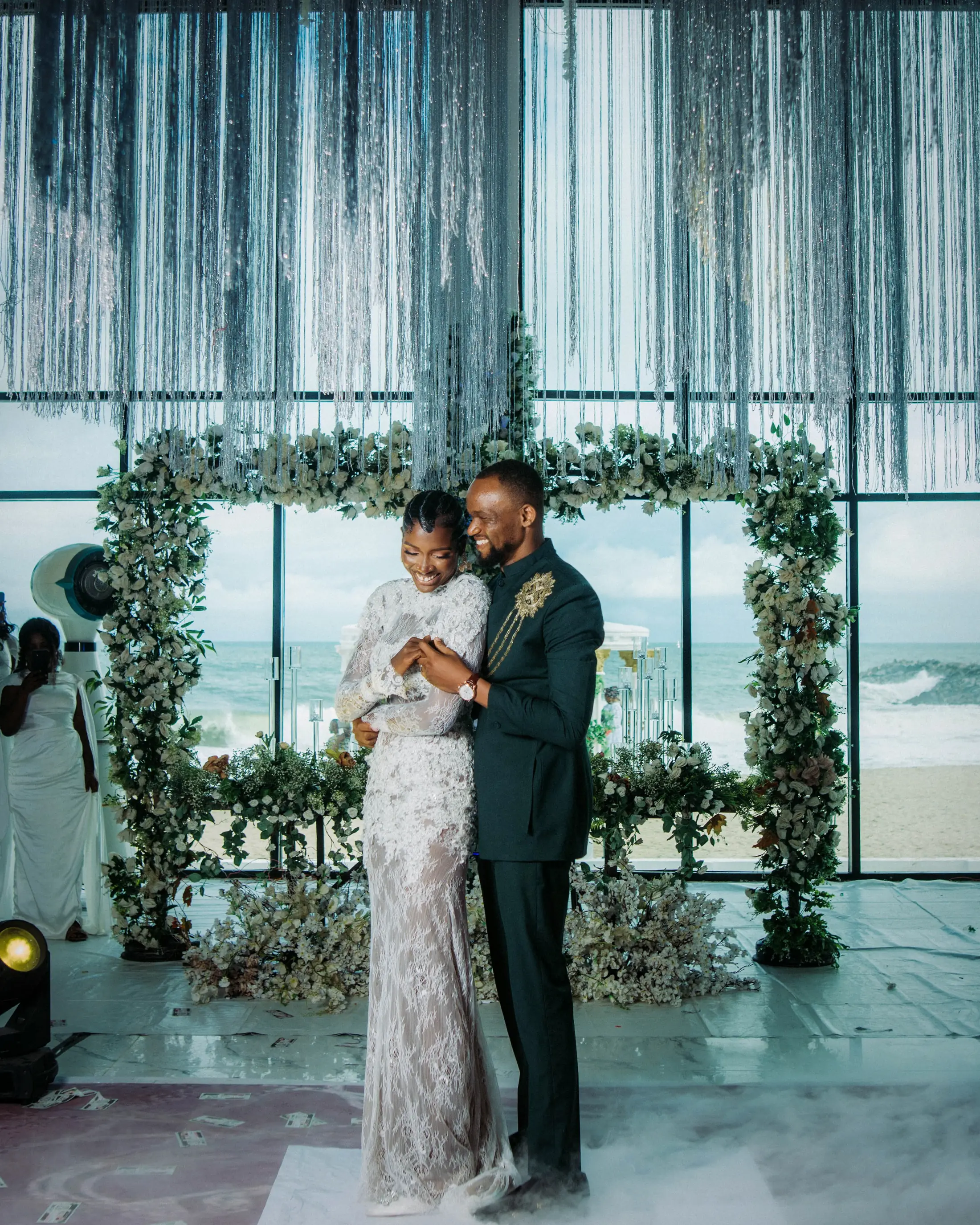 Bride and groom in the hall, the sea behind the glass