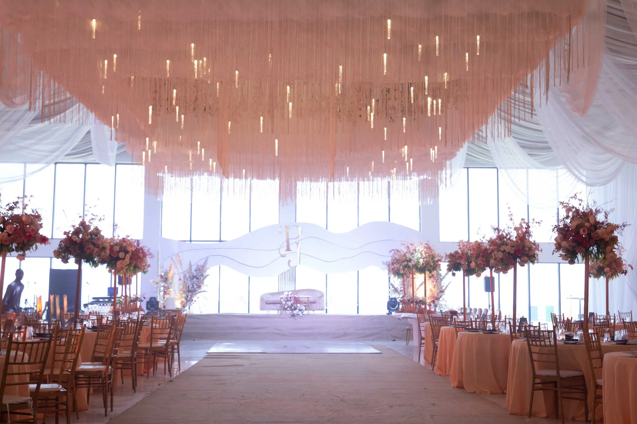 The hall dressed for a reception, flowers and draped fabric